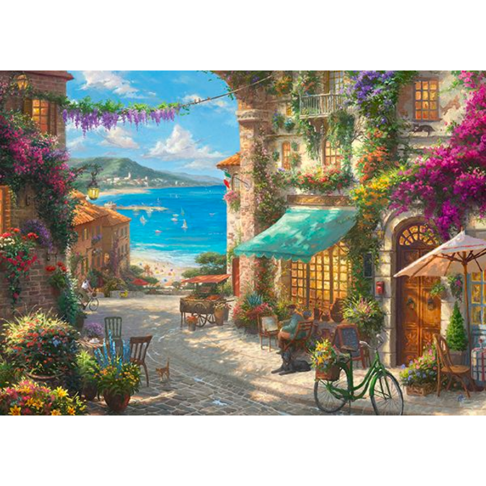 Adult puzzle featuring Thomas Kinkade's Café on the Italian Riviera, with vibrant scenic artwork by Schmidt.