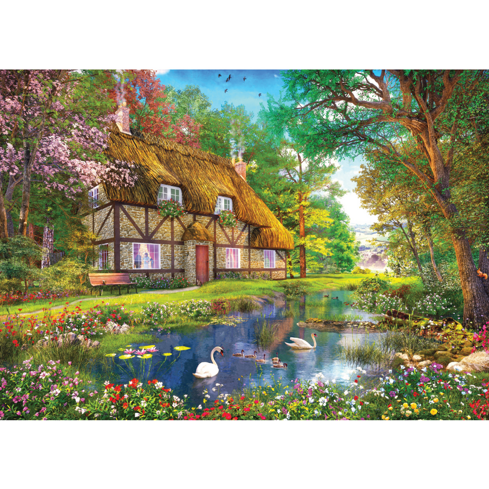 Falcon de Luxe Waterside Cottage adult puzzle featuring a charming lakeside scene with cottages and boats.